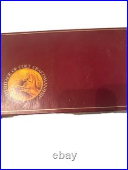 Colt handgun box, specifically identified as a maroon 150th-anniversary box